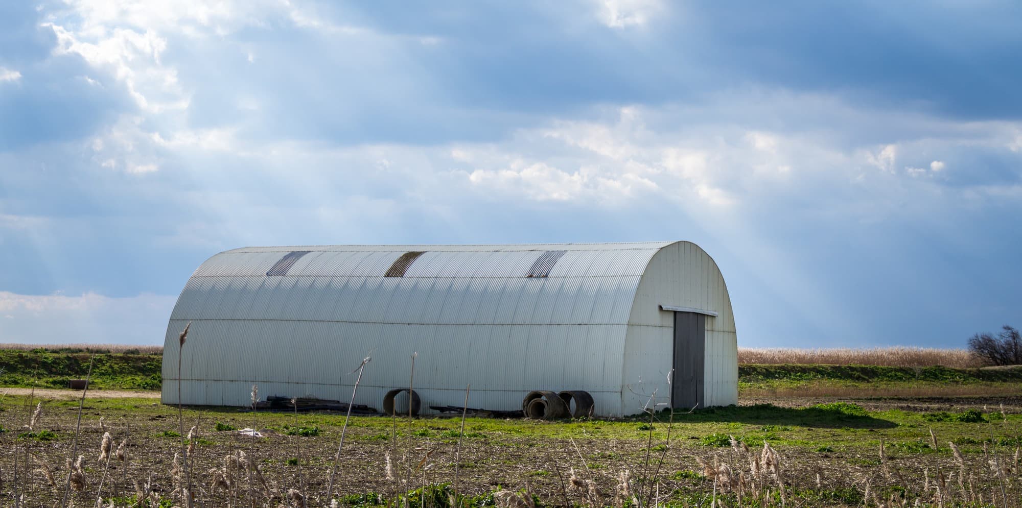 A large, newly fabricated industrial shed.